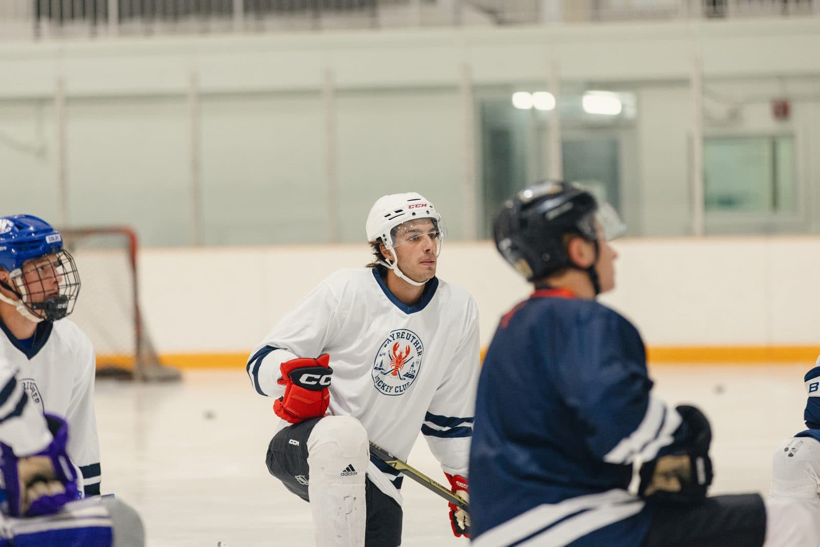Players and coaches on one knee during a drill at a BHC camp