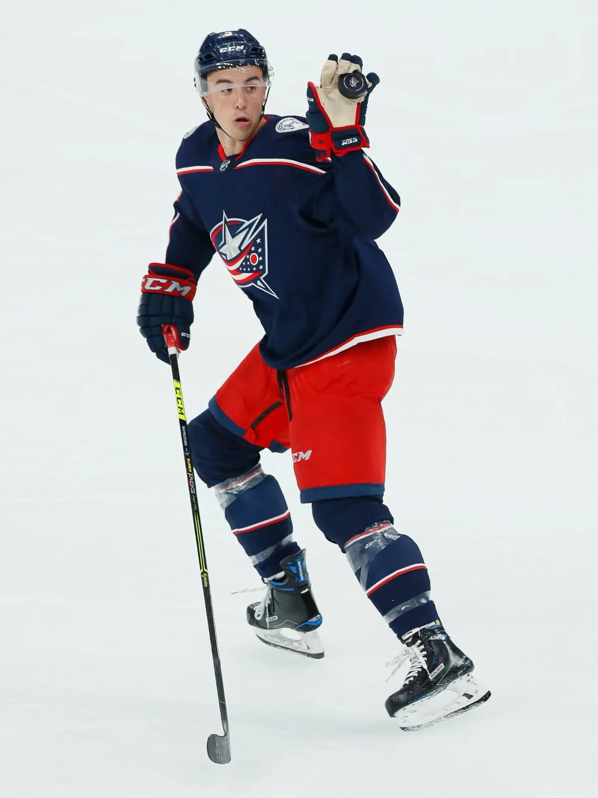 Gavin Bayreuther in a Columbus Blue Jackets jersey, skating with a puck in his glove
