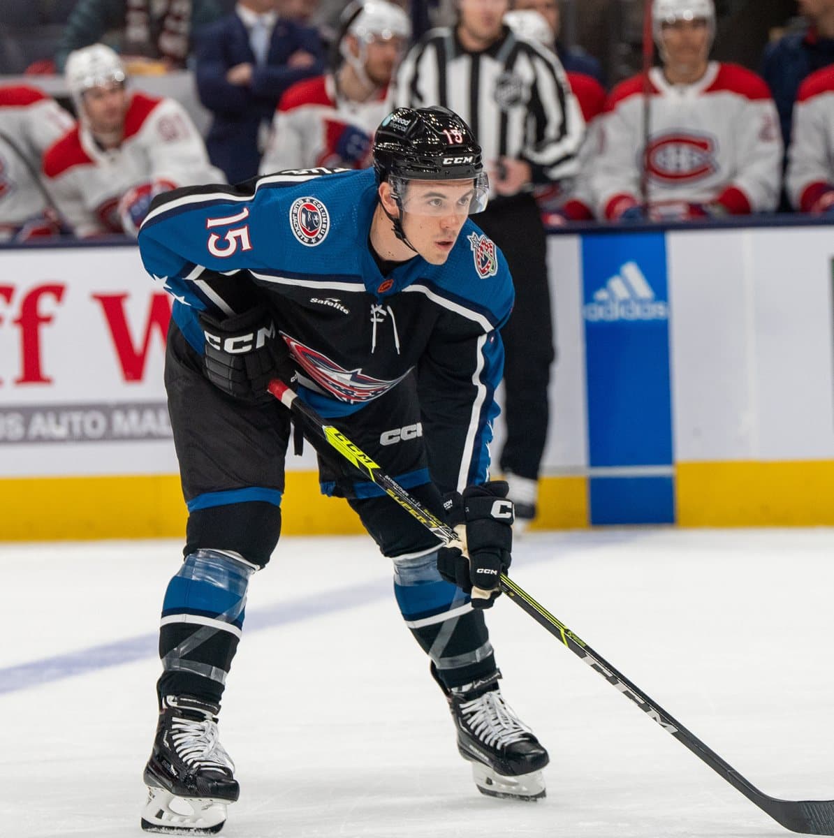Gavin Bayreuther in a Columbus Blue Jackets jersey, ready at a faceoff